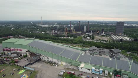 Aerial-view-of-Indoor-ski-slope,-Bottrop-Germany-with-Industry-in-background