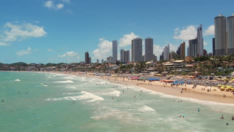 Scenic-beach-full-of-Tourists,-Ponta-preta-Skyline,-Summer-Destination,-Brazil