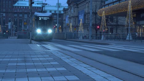 Blue-light-evening-transit-tram-on-street-in-front-of-Ateneum-Gallery