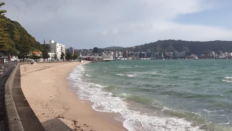 The-popular-Oriental-Bay-beach-and-waterfront-deserted-of-people-on-a-windy-day-in-the-capital-Wellington,-New-Zealand-Aotearoa