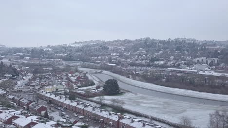 Track-forward-panning-drone-shot-of-snowy-Exeter-over-the-River-Exe-CROP