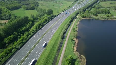 Aerial-footage-of-the-highway-near-the-lake-in-Europe-Holland-in-4K