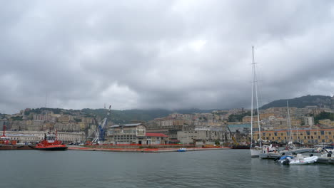Genoa-harbor-and-residential-area-under-a-cloudy-sky,-steady-scene