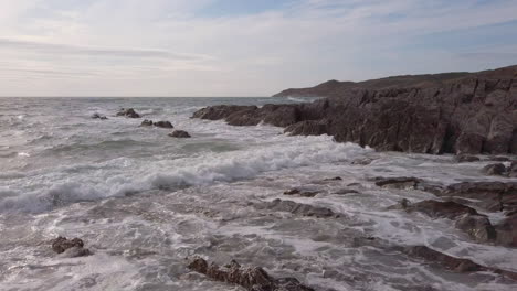 Waves-Breaking-at-a-Rocky-Cove-in-Devon-during-Sunset-in-Slow-Motion