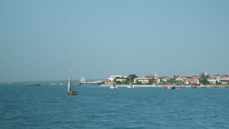 Sailing-boat-underway-near-the-coast-of-Zanzibar's-Stone-Town-on-a-clear-sunny-day