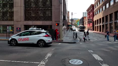 Cruise-self-driving-electric-vehicle-with-LIDAR-sensors-on-roof-accelerating-and-driving-past-in-San-Francisco,-California,-USA