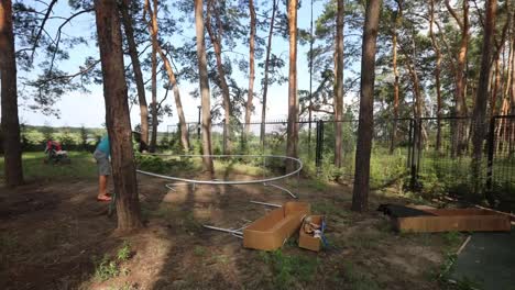 Time-lapse-of-a-man-assembling-a-trampoline-in-his-backyard