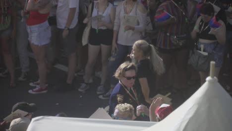 Woman-Hugging-Police-Officer-Marching-in-River-City-Pride-Parade-in-Jacksonville,-FL