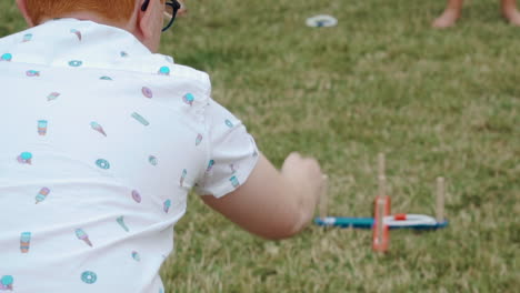 ginger-haired-boy-playing-ring-toss-SLOW-MOTION
