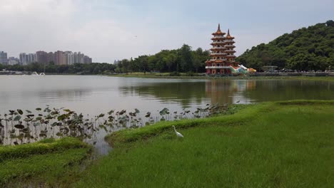 Panorama-of-the-Dragon-and-Tiger-Pagodas-at-Lotus-Pond-with-a-stork-in-the-foreground