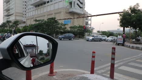 Traffic-passes-by-at-a-traffic-signal-in-New-Delhi,-India