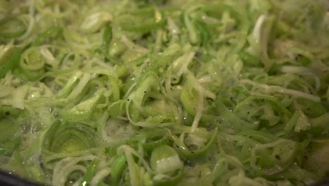 EXTREME-CLOSE-UP-Sliced-leeks-frying-in-butter