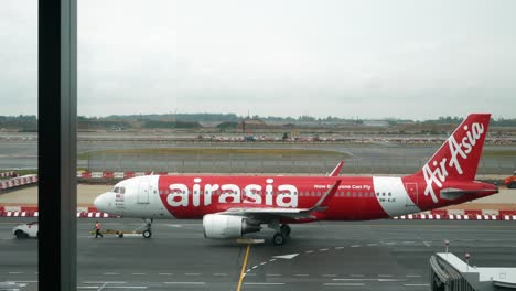 Landscape-view-of-Singapore-airport-with-Thai-Airasia-airline's-plane-taxing-in-Singapore-Changi-Airport