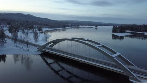 A-bridge-in-a-rural-frozen-landscape-of-Sweden,-during-winter