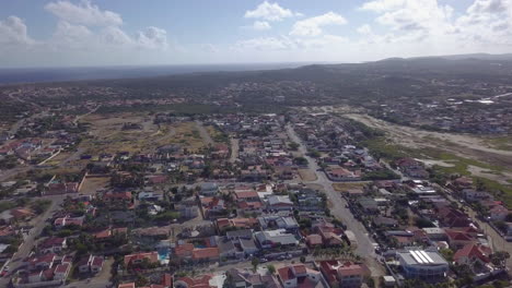 Aerial-pedestal-down-towards-a-neighbourhood-in-Noord,-Aruba