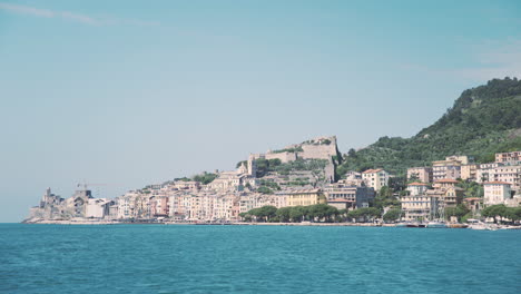 Portovenere-seen-from-the-water,-dolly-move-travel-from-a-boat