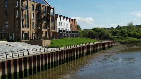 Aerial-view-of-Redrow-Homes-development-in-Strood,-Kent-named-'temple-Wharf'-drifting-over-the-River-Medway-to-reveal-new-build-housing