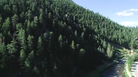 Mountains-and-a-road-in-a-drone-pan-framed-by-two-tripod-shots