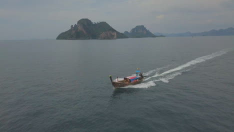 Aerial-of-water-taxi-boat-off-the-coast-of-Thailand-at-sunset