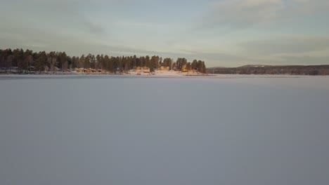 Frozen-lake-in-Falun,-Sweden-during-a-cold-winter-in-December,-filmed-with-a-drone