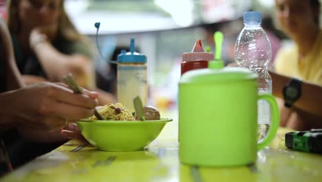 Shot-of-someone-eating-their-Indonesian-food-and-playing-with-their-noodles