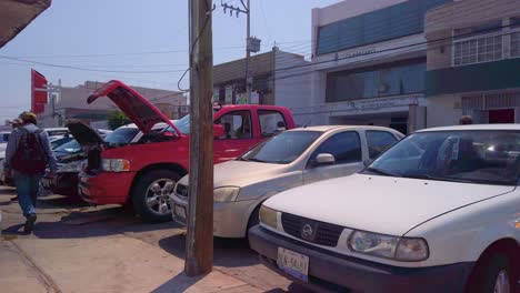Red-pickup-with-hood-open-being-repaired-in-the-streets
