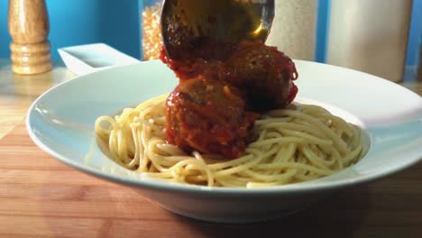 Fresh-Homemade-Meatballs-Being-Added-to-Spaghetti-on-Kitchen-Counter