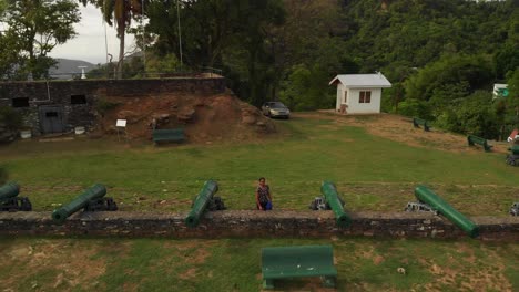 A-model-standing-at-a-fort-built-in-1804-with-original-canons-on-the-Caribbean-island-of-Trinidad