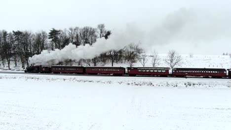 Aerial-restore19th-century-Strasburg-Railroad-rolls-across-the-snowy​-Pennsylvania-landscape