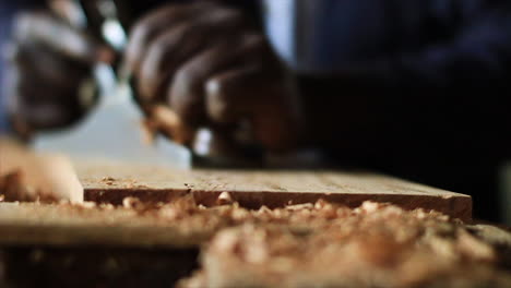 Close-up-of-Ugandan-man's-hands-wood-working