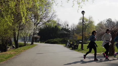 Three-Young-Girls-Jogging-In-The-Park,-Slow-Motion