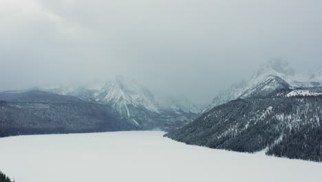 Aerial-over-frozen-Redfish-Lake-with-Sawtooth-mountains-looming-in-background