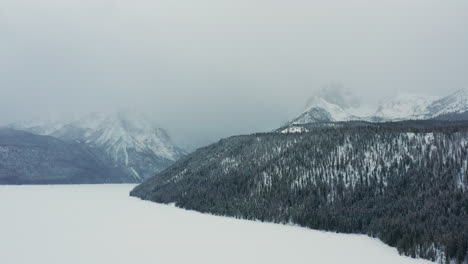 Aerial-over-winter-Redfish-Lake-moving-towards-foggy-Sawtooth-Mountains
