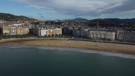 Drone-shot-of-San-Sebastian---drone-is-facing-the-busy-beach-promenade