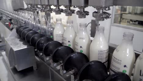 Milk-Production-Line,-Machine-Fills-Bottles-in-Factory