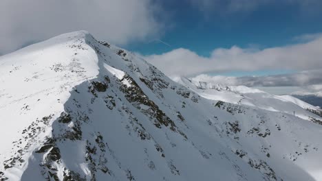 Panning-Slowmotion-Arial-Drone-shot-revealing-Todorka-and-the-Bansko-Ski-Lift,-in-Bulgaria