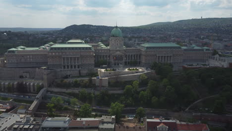 Drone-shot-of-Royal-Palace-in-Budapest,-Hungary---drone-is-circling-to-right-while-focusing-the-complex