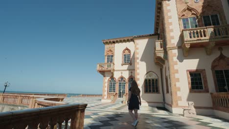 Woman-walks-outside-of-a-mansion-in-Sarasota-Florida