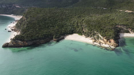 Drone-shot-of-Praia-de-Galapinhos-near-Lisbon---drone-is-flying-towards-a-little-lonely-beachside