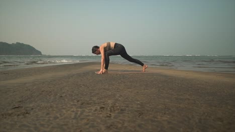 Dehnende-Yoga-Frau-Am-Strand-Beim-Sonnengruß-Asana-Flow,-Gesundes-Brünettes-Training