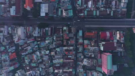 early-morning-top-down-drone-high-view-of-street-and-rooftops-in-a-busy-and-densely-populated-area-featuring-main-road-and-church-building