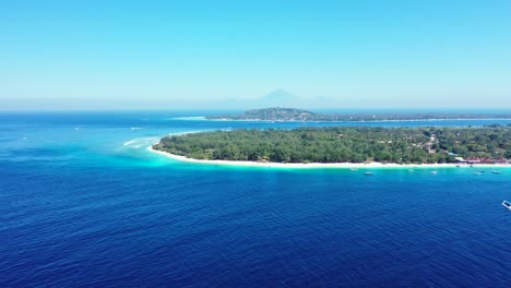 Paradise-vacation-gateway-of-tropical-islands-with-long-white-beaches-and-lush-vegetation-surrounded-by-blue-azure-sea-under-light-blue-clear-sky-in-Gili