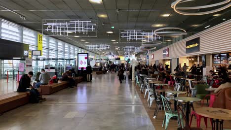 Panning-view-of-restaurants-and-cafes-departure-side-at-the-Toulouse-airport-in-France