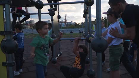 Two-Men-Teaching-Parkour-Stunts-To-Young-Boys-In-A-Training-Park-In-The-City-Of-Cluj,-Napoca,-Romania---Close-up-Shot