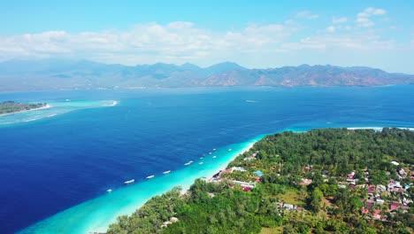 Paradise-panoramic-seascape-with-blue-sea-stream-between-tropical-islands-surrounded-by-turquoise-water-and-white-waves,-mountains-background-in-Indonesia