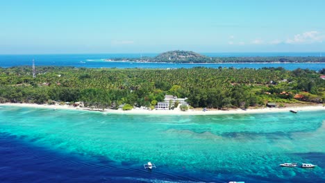 Beautiful-blue-turquoise-lagoon-with-coral-reefs-on-shoreline-of-tropical-island-with-exotic-white-beach-and-trees-forest-in-Indonesia
