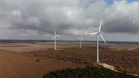 Right-side-drone-flight-around-running-wind-turbines