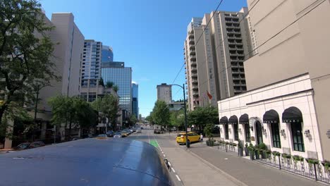 POV-from-rooftop-of-a-tour-bus-while-driving-in-city-center-Vancouver-BC-on-Burrad-Street