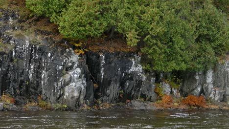 Extended-pan-shot-of-beautiful-river-shore-made-by-dramatic-natural-stone-walls