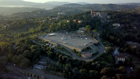 Piazzale-Michelangelo-in-the-south-of-Florence-Italy-with-a-statue-of-David-replica-and-vistas-of-the-city,-Arno-river-and-San-Niccolo-Tower,-Aerial-flyover-shot